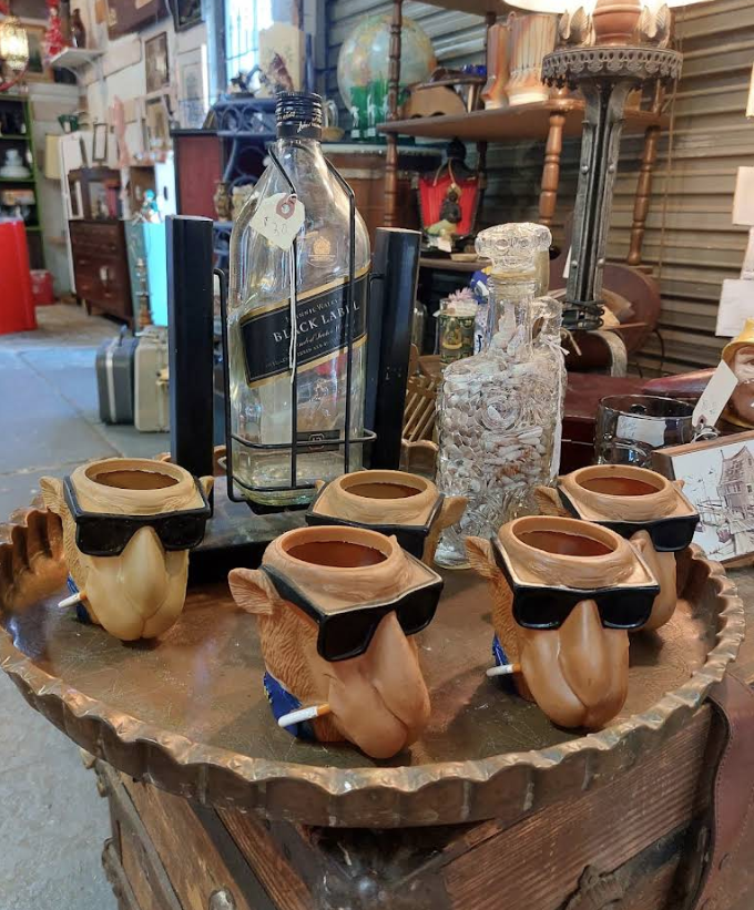 Curated vintage collectibles including brass lamp and ceramics